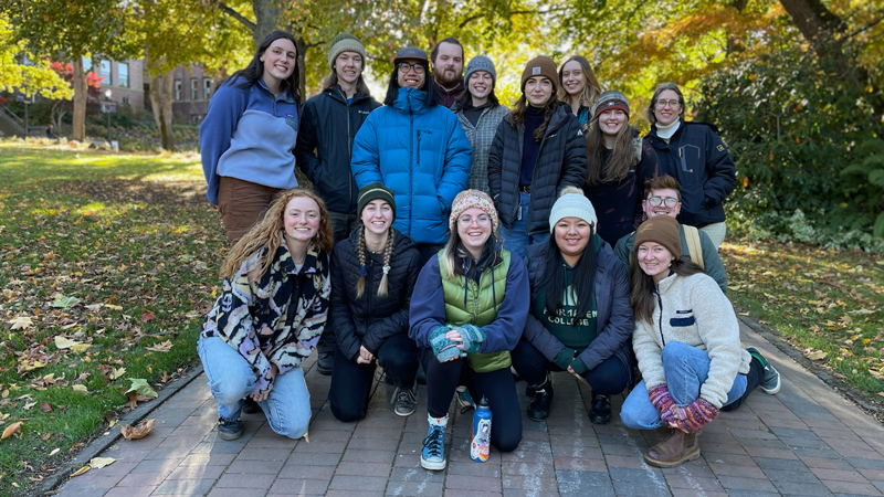 A group of Outdoor Wellness Program mentors wearing winter clothing poses on Western's campus