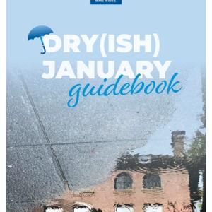 The title Dryish January Guidebook is superimposed on an image of the reflection of Old Main in a rain puddle