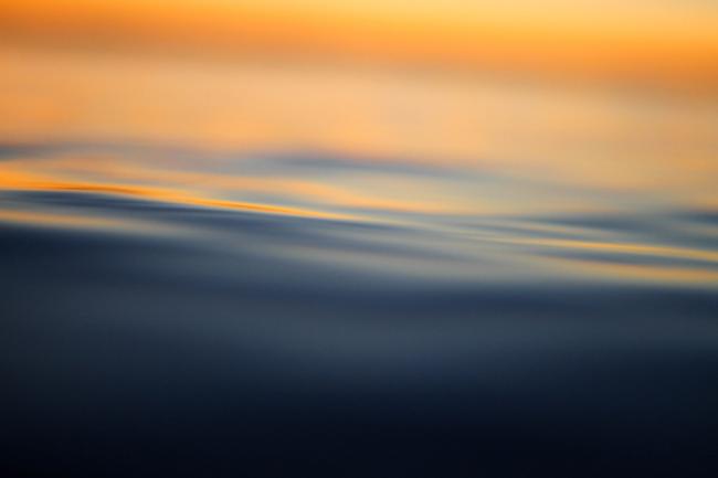 close-up on a smooth wave at sunset
